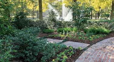 Lush garden with fountain and brick pathway